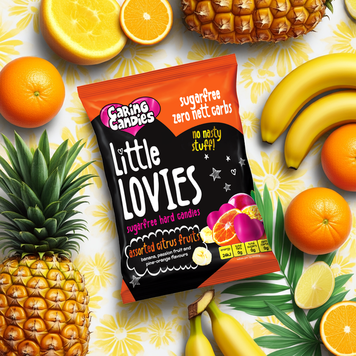 Caring Candies Little Lovies assorted citrus flavours package surrounded by fruits on a colorful background
