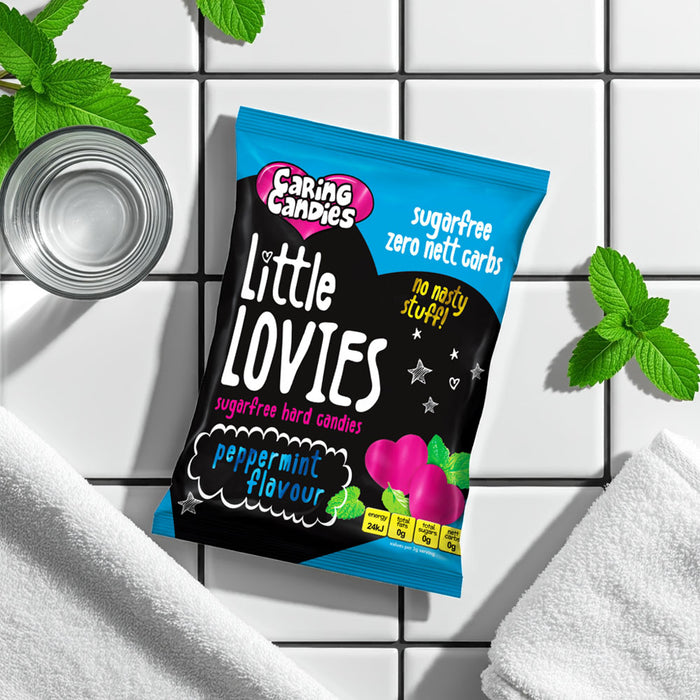 Pack of Caring Candies sugarfree peppermint Little Lovies sweets on a white tiled background with mint 