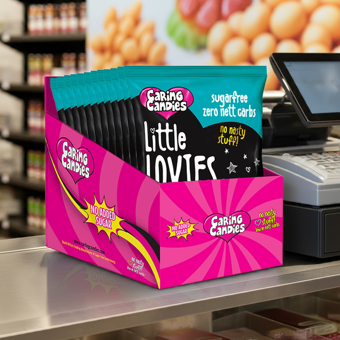 Box of Caring Candies Little Lovies on a store shelf with a cash register in the background.