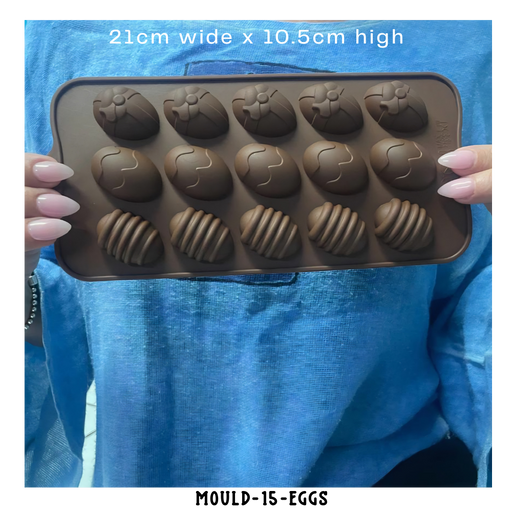 brown silicone easter chocolate and soap mould with various shapes held by a person wearing a blue shirt.