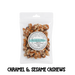 Packaged sugarfree caramel and sesame cashews with a label on a clear background
