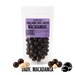 Packaged  no added sugar dark chocolate-coated macadamias with a visible brand logo on a clear background.