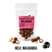 Packaged no added sugar milk chocolate-coated macadamia nuts with a pink label on a white background.