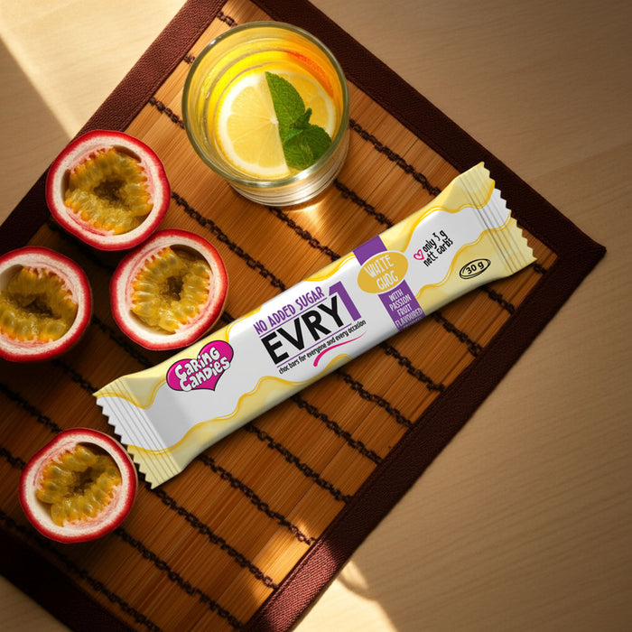 sugarfree caring candies milk chocolate EVRY1 bar with a glass of lemonade and passion fruit on a wooden mat