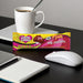 Caring Candies plain milk sugar-free chocolate bar on a desk with a cup of coffee, mouse, and notebook.
