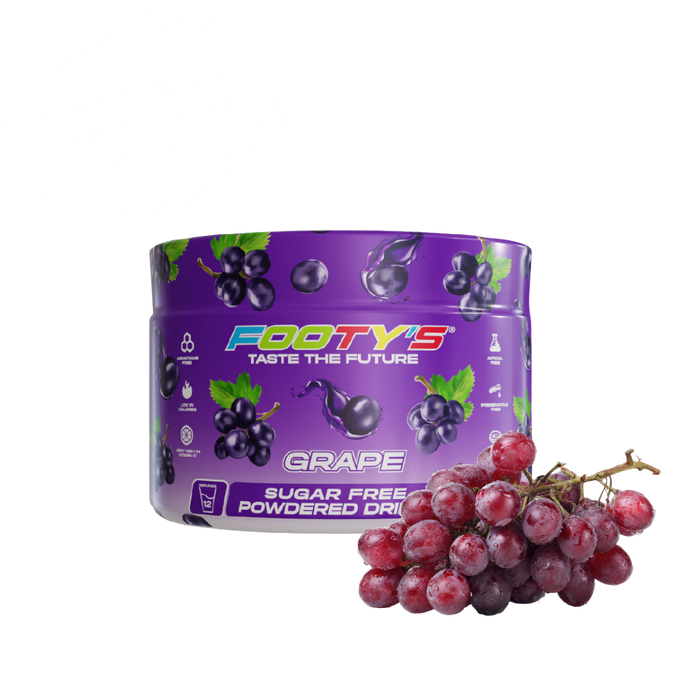 A purple tub of Footys Grape flavour sugar free powdered drink mix, shown next to a fresh cluster of red-purple grapes on a plain white background.