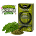 Akan Moringa Leaf Tea box in green packaging shown next to fresh green moringa leaves and loose dried tea powder on a white background, with a large 'Original Moringa Herbal Tea' graphic overlay on the left.
