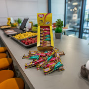 An assorted retail display box of 30 50g caring candies sugar-free premium milk chocolate bars - milk, mint, and toffee flavours