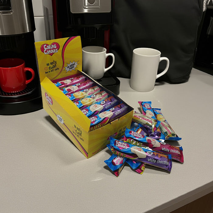 A retail display box of 30 50g caring candies sugar-free assorted white chocolate bars on a counter