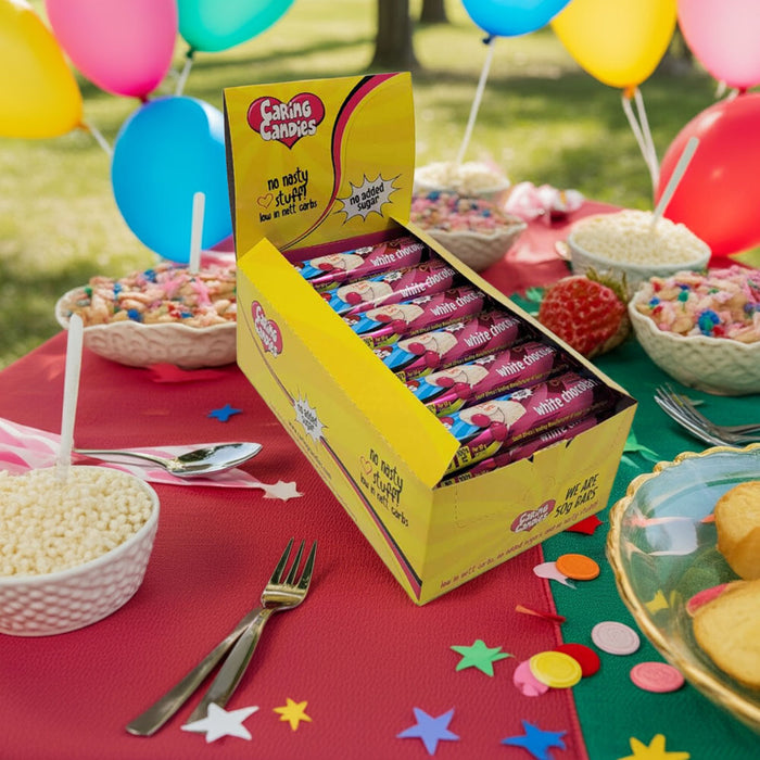 A retail display box of 30 50g caring candies sugar-free premium white chocolate bars with sour cherry flavoured crunch on a kids birthday party table