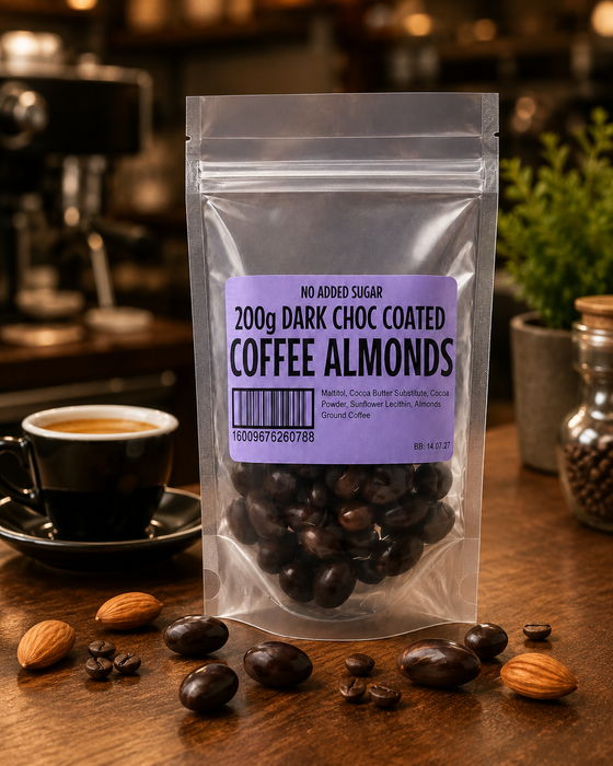 Packaging of no added sugar dark chocolate-coated coffee almonds on a wooden surface with coffee beans and almonds.