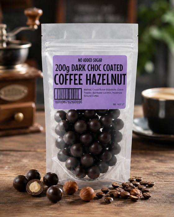Packaged  no added sugar dark chocolate-coated coffee hazelnuts with a purple label on a wooden surface.