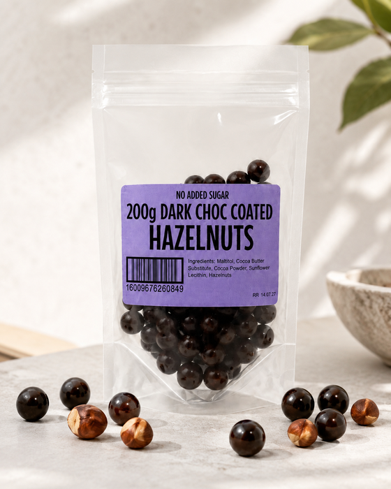 Packaged  no added sugar dark chocolate-coated hazelnuts with a purple label on a light background