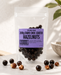 Packaged  no added sugar dark chocolate-coated hazelnuts with a purple label on a light background