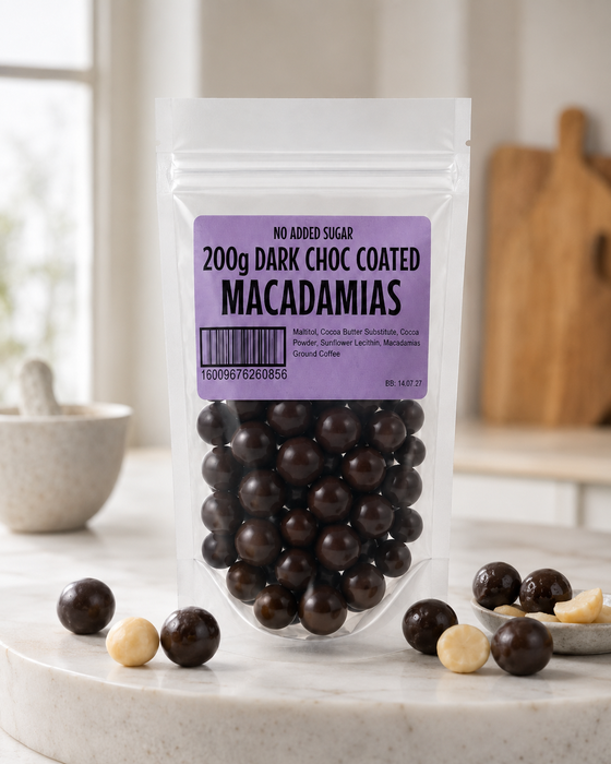 Packaged  no added sugar dark chocolate-coated macadamias with a purple label on a marble surface.