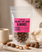 Packaged no added sugar milk chocolate coated almonds with a pink label on a neutral background