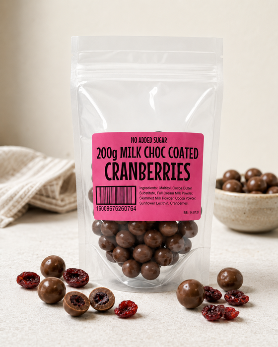 Packaged no added sugar milk chocolate coated cranberries with a pink label on a light background