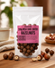 Packaged no added sugar milk chocolate coated hazelnuts with a pink label on a wooden surface.