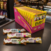 Display of EVRY1 candy bars and packaging on a store counter.