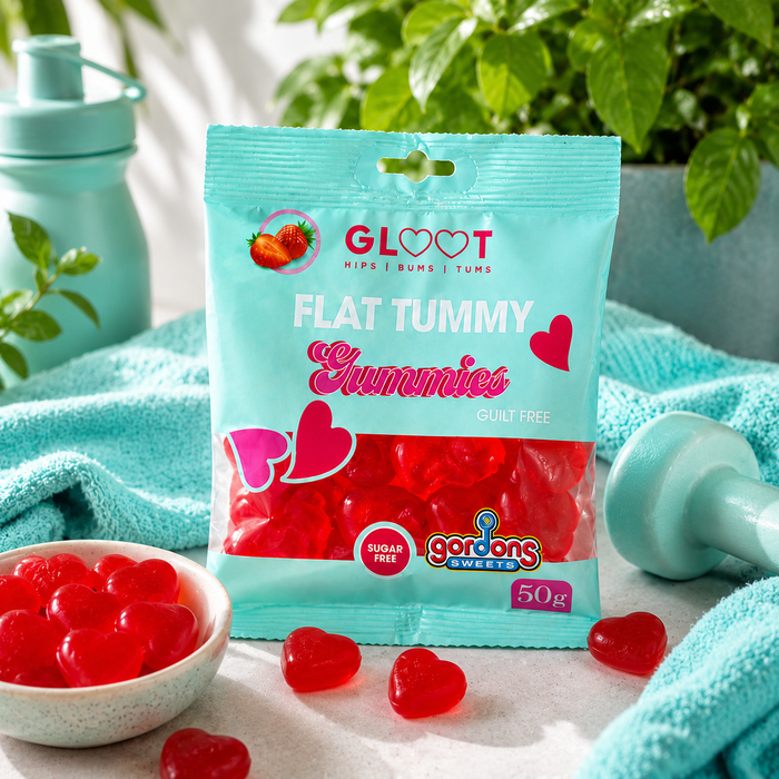 Packaging of Gloot Sugarfree Flat Tummy Gummies with gummies around on a light blue towel.