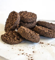 Chocolate cookies on a white surface with a blurred background