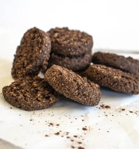 Chocolate cookies on a white surface with a blurred background