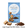 A bag of Lago Be Goodie Sugar Free Mini Party Cacao Cocoa wafers, shown with several mini wafers and cocoa powder piles on a white background.