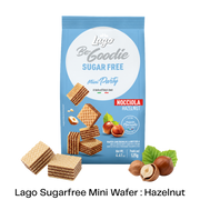 A blue bag of Lago Be Goodie Sugar Free Mini Party Nocciola Hazelnut wafers, shown with several hazelnut-filled wafers and hazelnuts arranged around it on a white background with a black text banner at the bottom.