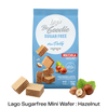 A blue bag of Lago Be Goodie Sugar Free Mini Party Nocciola Hazelnut wafers, shown with several hazelnut-filled wafers and hazelnuts arranged around it on a white background with a black text banner at the bottom.