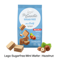 A blue bag of Lago Be Goodie Sugar Free Mini Party Nocciola Hazelnut wafers, shown with several hazelnut-filled wafers and hazelnuts arranged around it on a white background with a black text banner at the bottom.