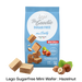 A blue bag of Lago Be Goodie Sugar Free Mini Party Nocciola Hazelnut wafers, shown with several hazelnut-filled wafers and hazelnuts arranged around it on a white background with a black text banner at the bottom.