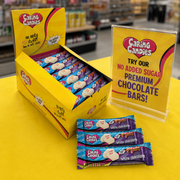 Caring Candies display with packaging and promotional sign in a store setting