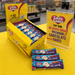 Caring Candies display with packaging and promotional sign in a store setting