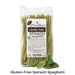 Packet of Glutenfree Pasta Regalo spinach spaghetti with spinach leaves in front of it