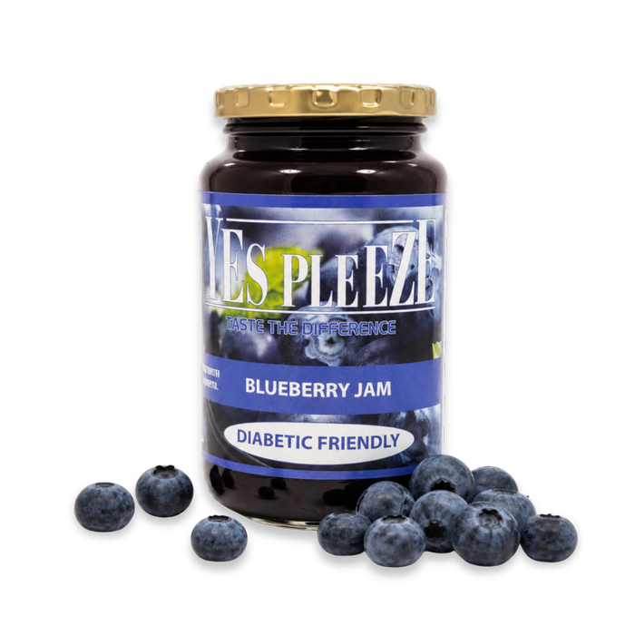 Bottle of Yes Pleeze No Added Sugar Blueberry Jam with fresh blueberries scattered around the bottom