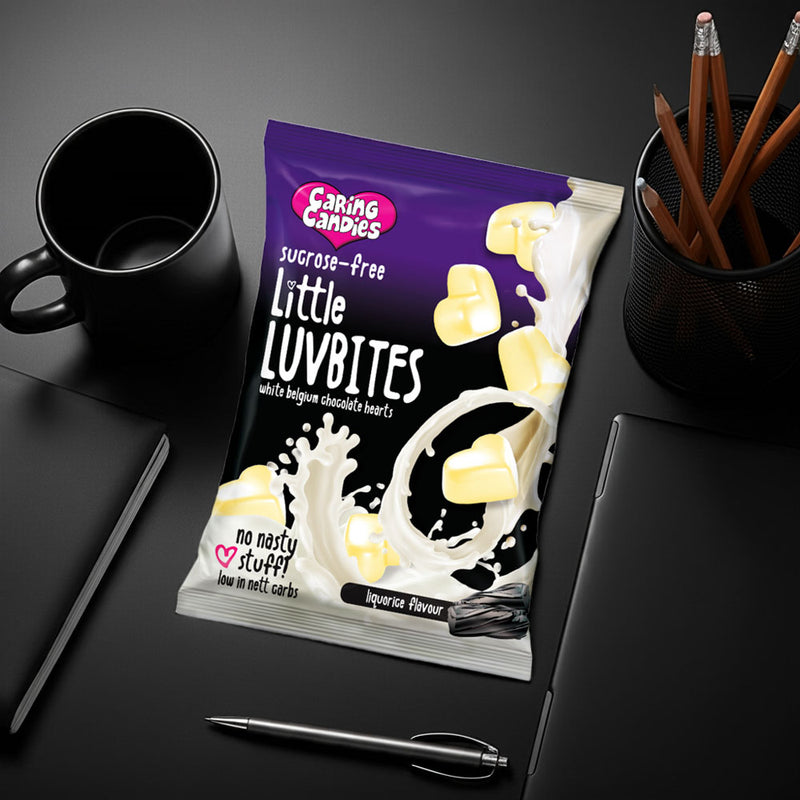 packet of caring candies sugarfree white chocolate heart little luvbites in a liquorice flavour on a black desk
