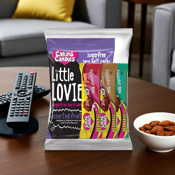 Packaging of Caring Candies Little Lovies on a table with snacks and remote controls in the background
