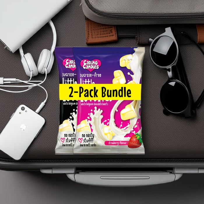 Two sugarfree Caring Candies Little LuvBites white chocolate hearts packets on a suitcase with travel items around