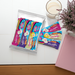 Assorted caring candies premium sugar-free chocolate bars with a cup of coffee and pink notebook on a white surface
